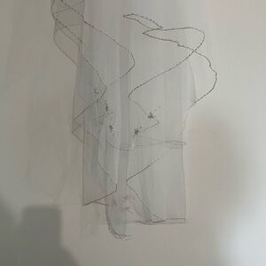 Elbow length white wedding veil edged in silver/glitter